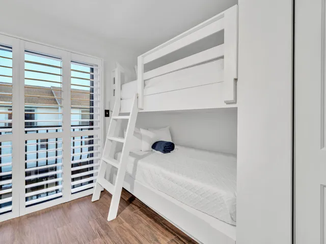 a large white bedroom with a bed and a television