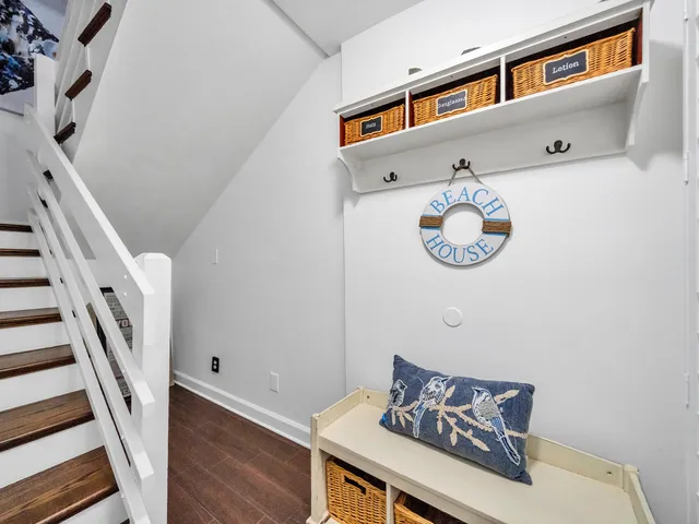 a kitchen with stainless steel appliances a stove a sink dishwasher a refrigerator and a oven with wooden floor