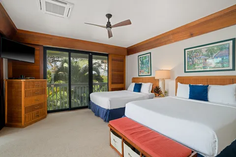 a living room with furniture a ceiling fan and a large window
