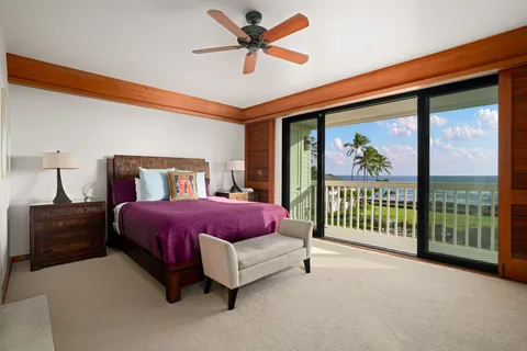 a spacious bedroom with a bed and a chandelier