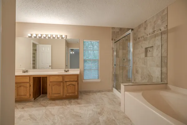 a bathroom with a bathtub and a shower