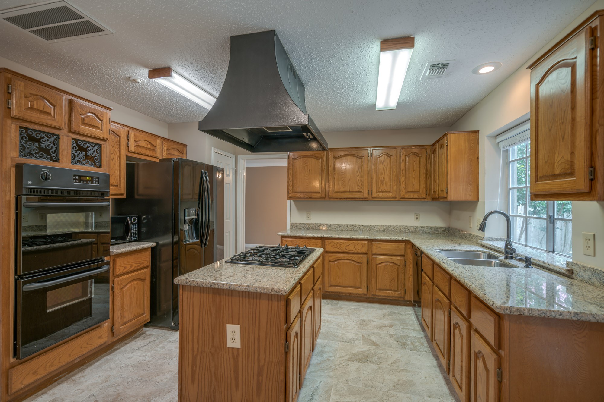 11 Robin Run Drive Spring, TX 77381 - Photo 6 of 25 a kitchen with stainless steel appliances granite countertop a sink stove and refrigerator