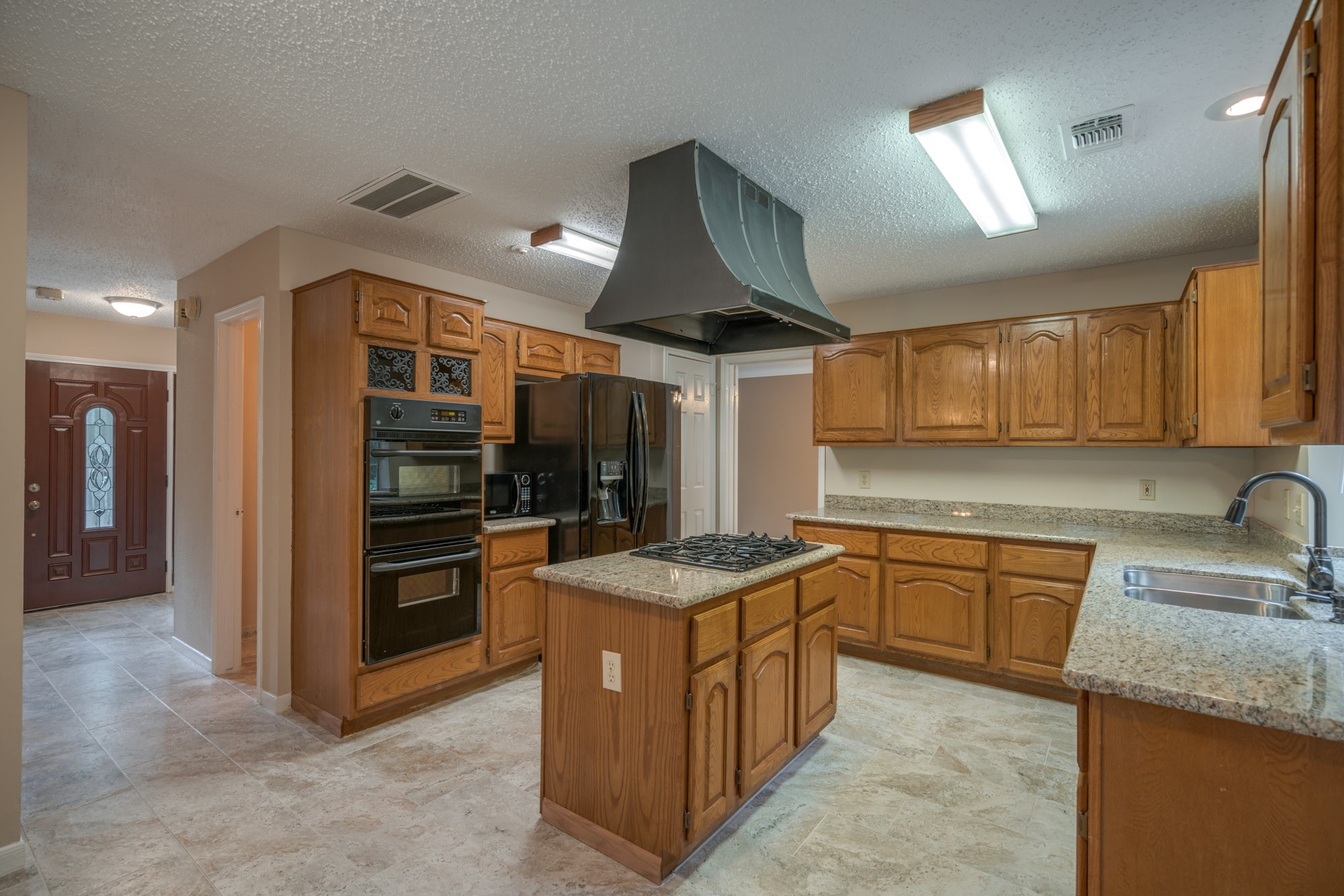 11 Robin Run Drive Spring, TX 77381 - Photo 7 of 25 a kitchen with granite countertop a sink and stainless steel appliances