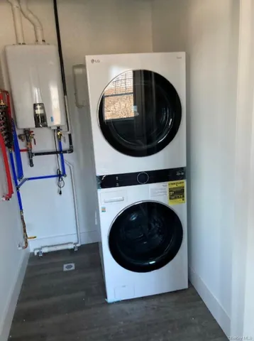 a utility room with wooden floor and washing machine