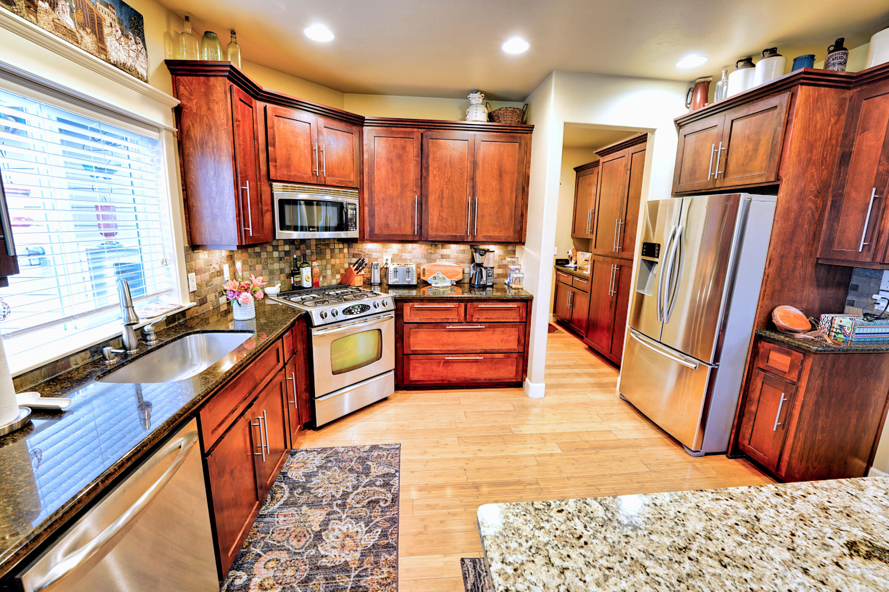2154 Rabun Way Central Point, OR 97502 - Photo 8 of 39 a kitchen with stainless steel appliances granite countertop a refrigerator a stove a sink and a cabinets
