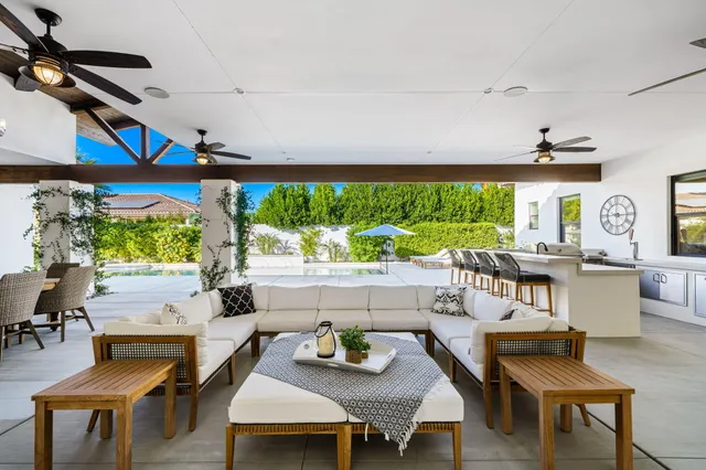 a spacious bedroom with a bed and a flat screen tv