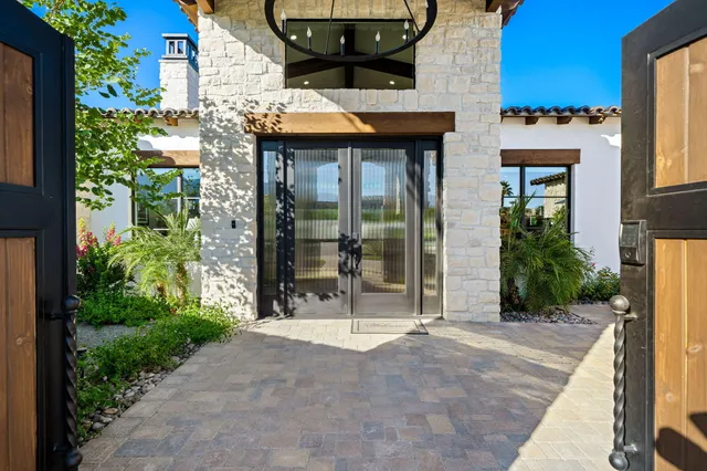 a front view of a house with a yard and outdoor seating