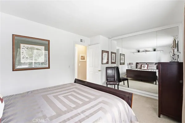 a bedroom with a bed and a couch
