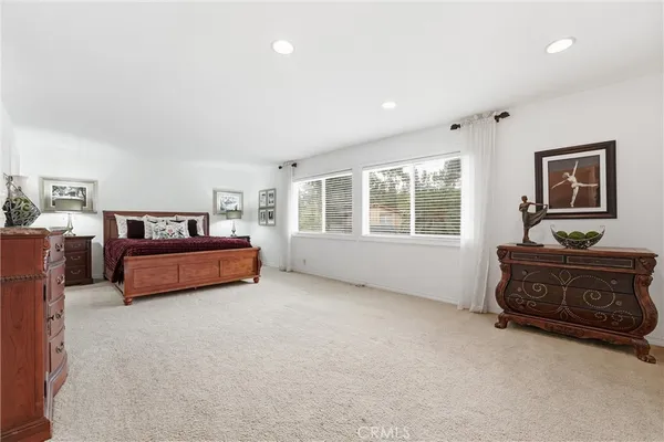 a spacious bedroom with a bed and window