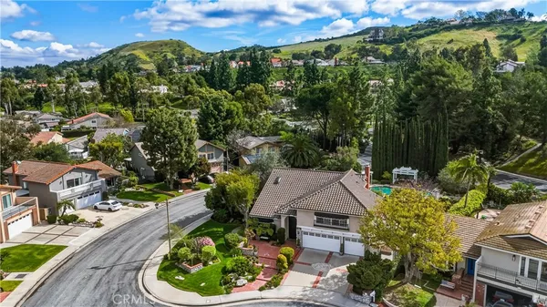 an aerial view of a house with garden space and street view