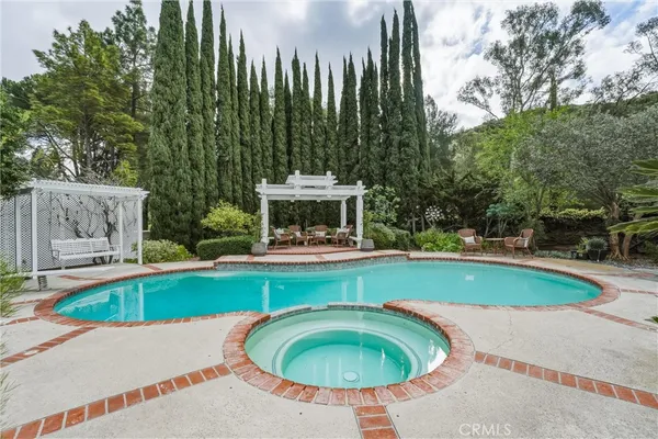 a swimming pool with outdoor seating and yard