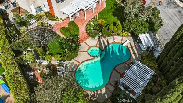 a view of a yard with flower plants and wooden fence