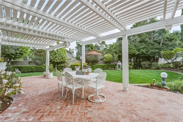 a view of a patio with a table chairs and a backyard