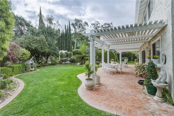 a view of a patio with furniture and garden