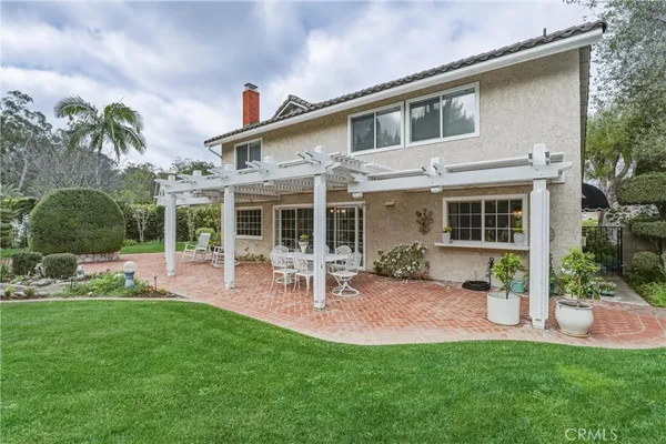 a view of a house with a yard and sitting area