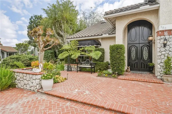 a front view of a house with a garden