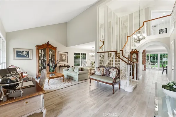 a living room with furniture a wooden floor and a large window