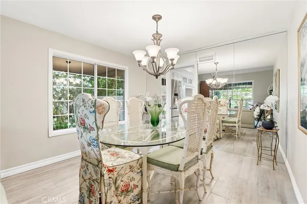 a view of a dining room with furniture wooden floor and chandelier