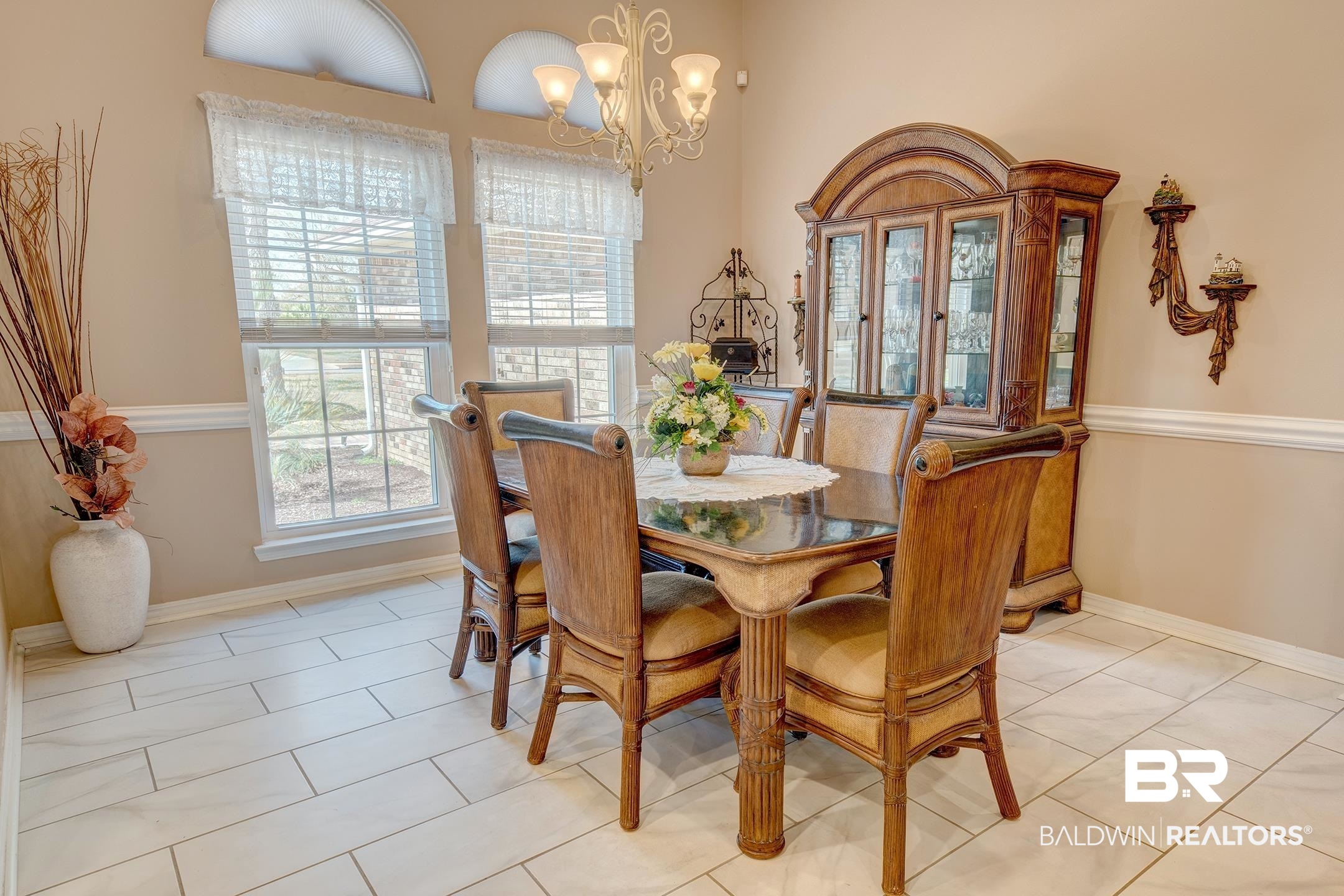 Dining room with suspended lighting and light tile patterned floors