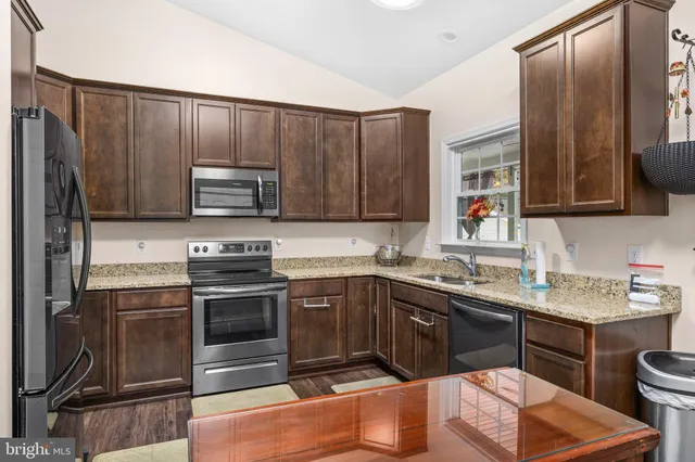 a kitchen with a sink stove and microwave