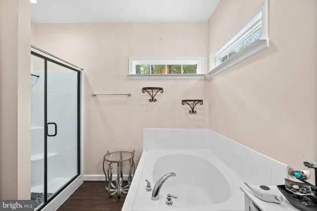 a bathroom with a bathtub and a shower