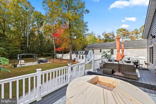 a view of balcony with two chairs and wooden fence