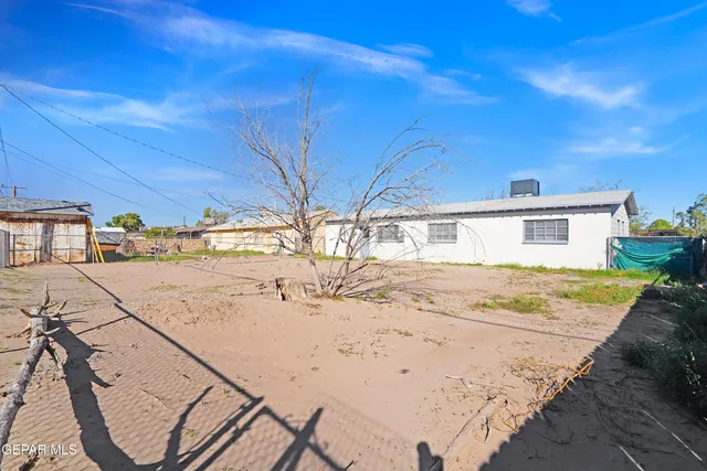 a view of a backyard with a barbeque grill and a beach