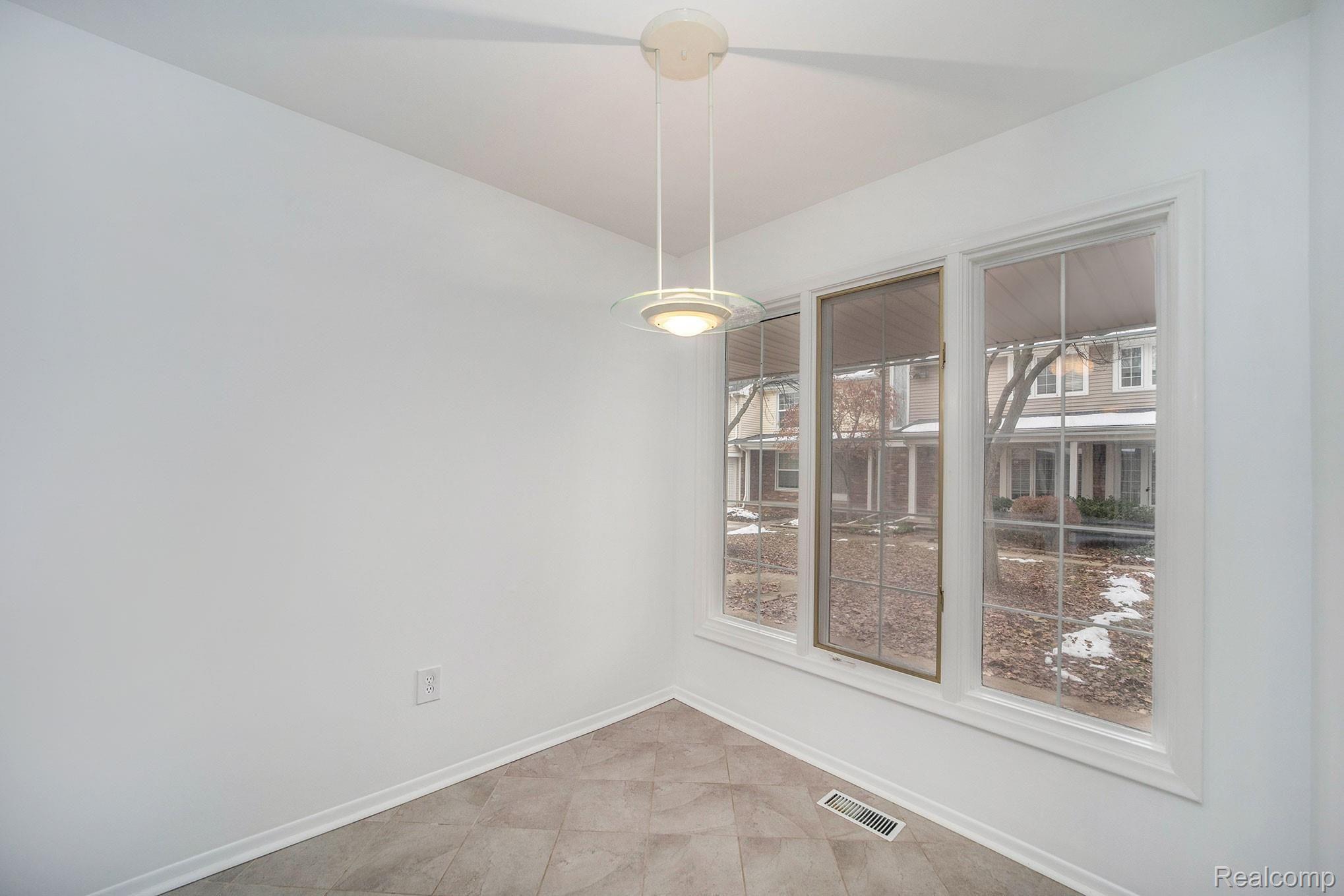 3443 Crooks Road Royal Oak, MI 48073 - Photo 10 of 30 Bright kitchen with a new range, & breakfast nook overlooking the courtyard.