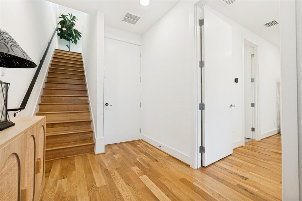 1952 Kearney Court Dallas, TX 75204 - Photo 4 of 24 a view of a hallway with wooden floor and staircase