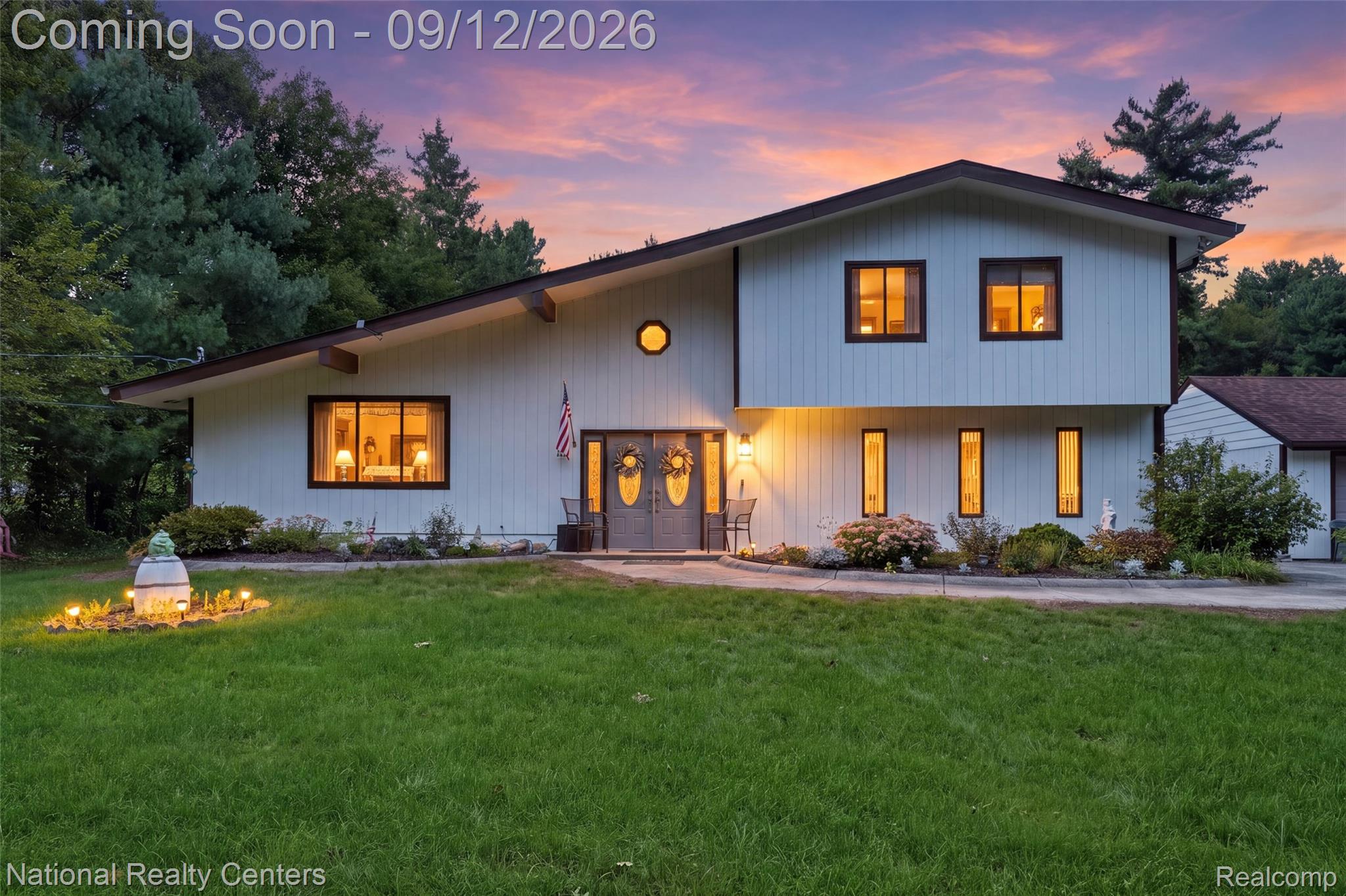 Exterior featuring a prominent sloped roofline, dual-entry doors, a circular window, and multiple rectangular windows