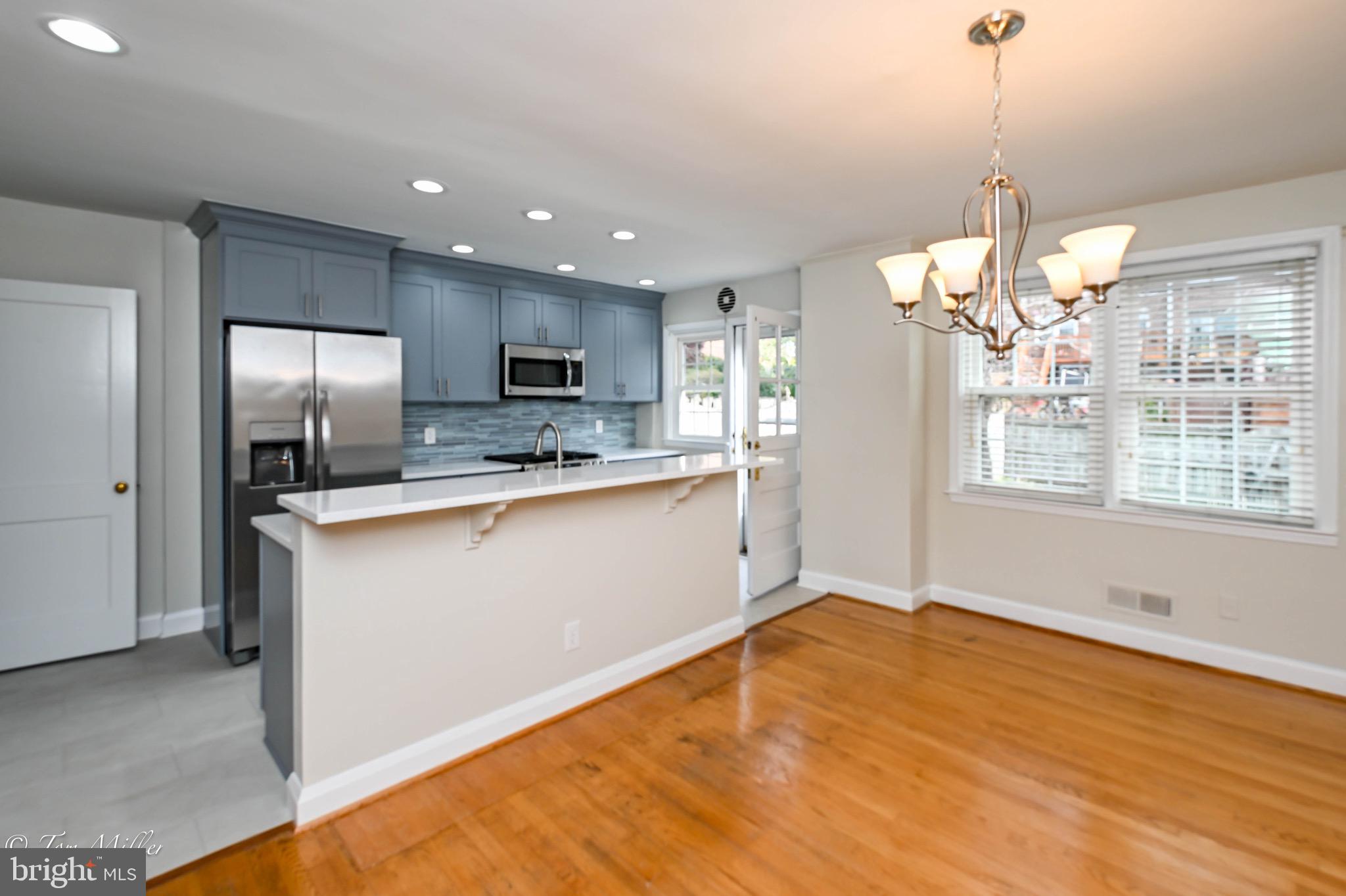 127 Stanmore Road Baltimore, MD 21212 - Photo 8 of 37 Dining Room with Chandelier & Eat In Island