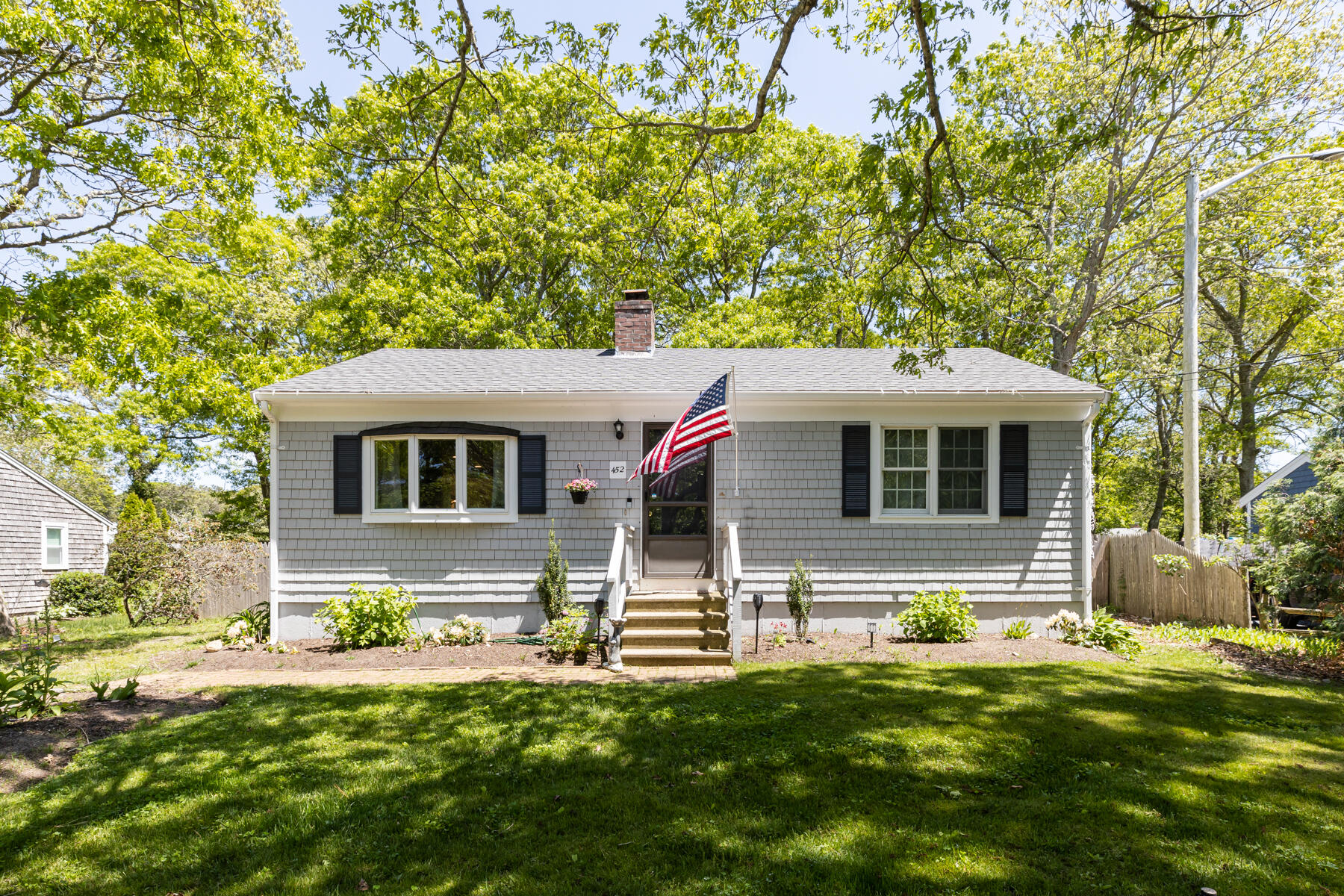452 Lincoln Rd Extension Hyannis, MA 02601 - Photo 1 of 25 a front view of a house with a yard