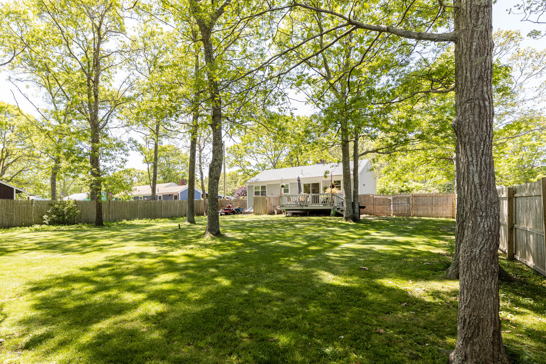 452 Lincoln Rd Extension Hyannis, MA 02601 - Photo 3 of 25 a view of a trees in front of a yard with plants and large trees