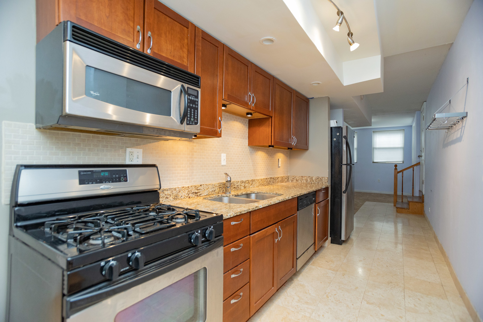 5745 North Ridge Avenue, Unit G Chicago, IL 60660 - Photo 8 of 16 a kitchen with a stove and a microwave