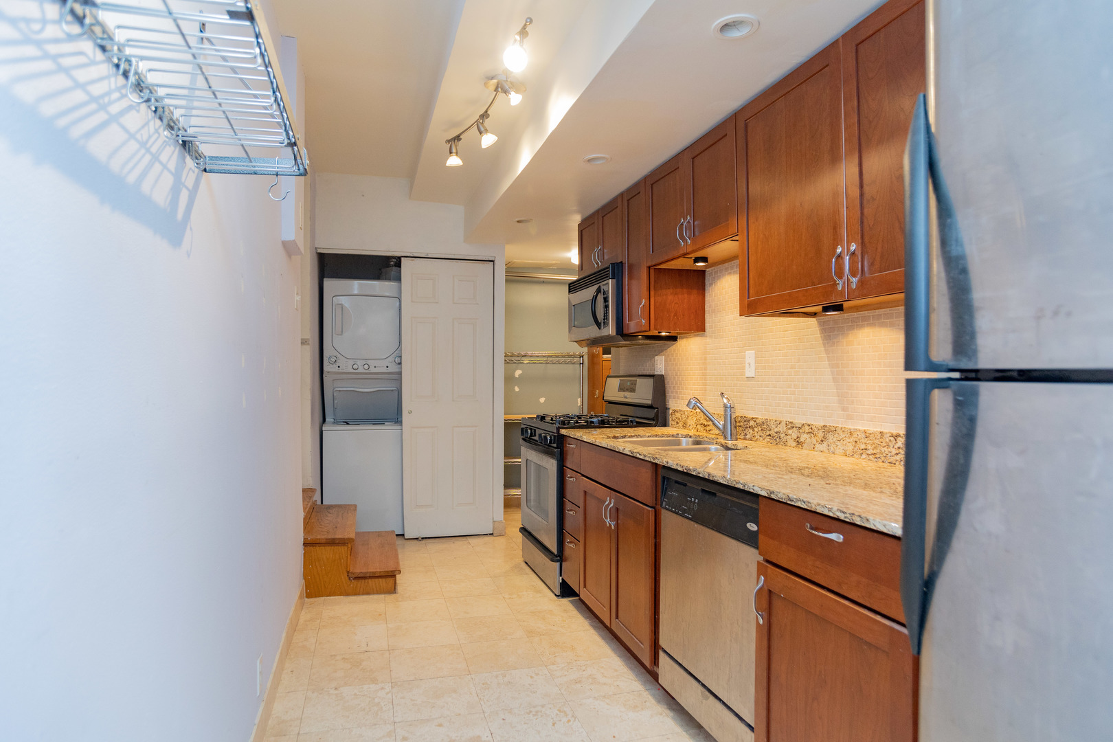 5745 North Ridge Avenue, Unit G Chicago, IL 60660 - Photo 9 of 16 a kitchen with stainless steel appliances granite countertop a sink and a refrigerator