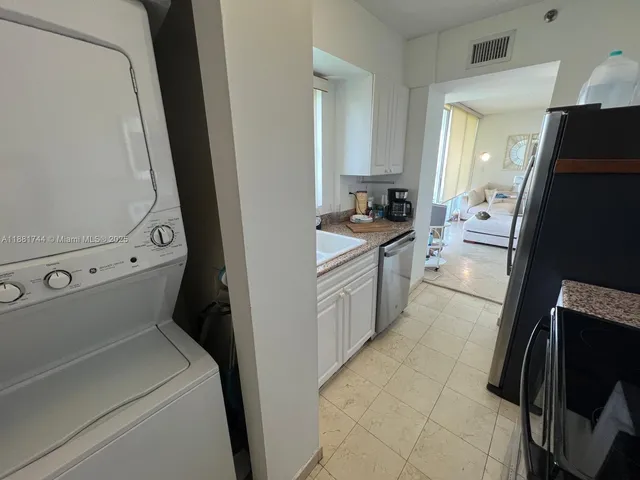 a kitchen with a refrigerator and a sink