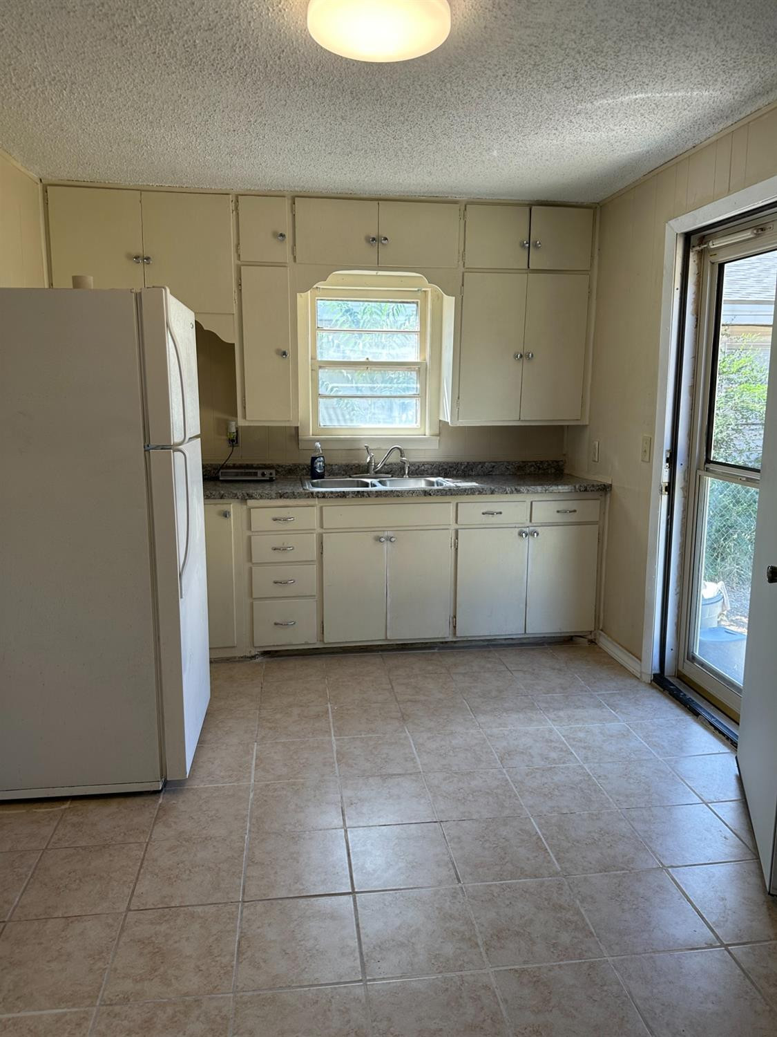 1110 46th Street Lubbock, TX 79412 - Photo 3 of 12 a kitchen with stainless steel appliances granite countertop a refrigerator a stove a sink and dishwasher