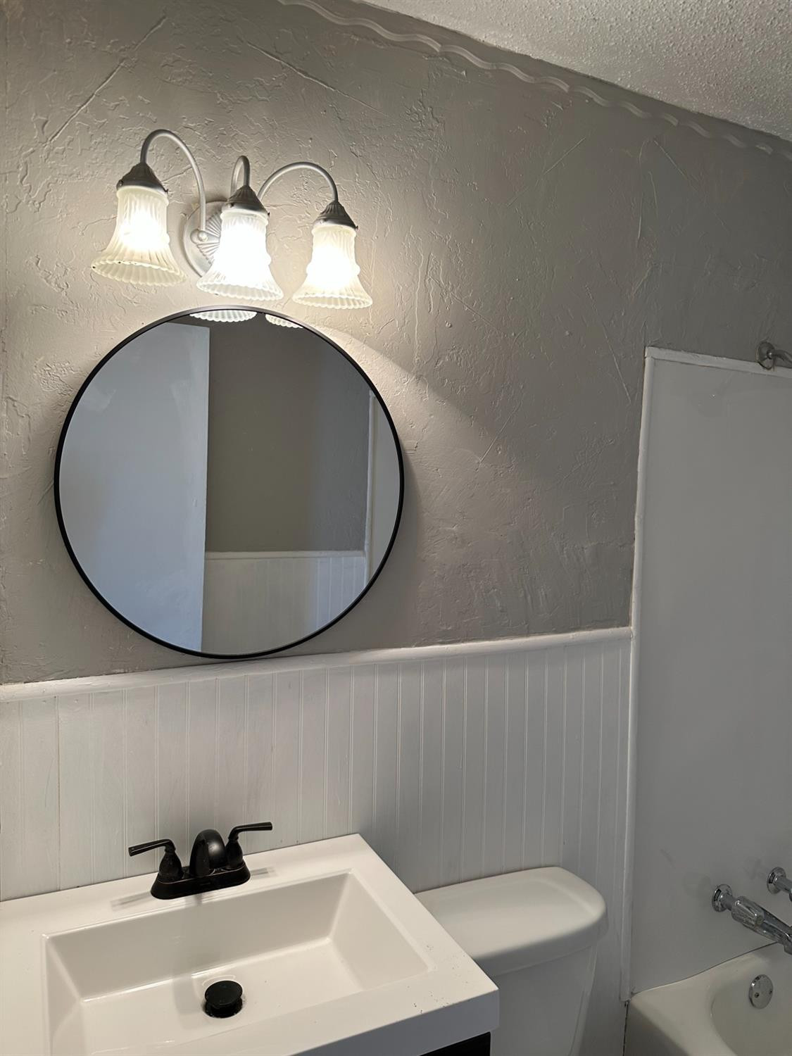 1110 46th Street Lubbock, TX 79412 - Photo 5 of 12 a bathroom with a sink and a mirror