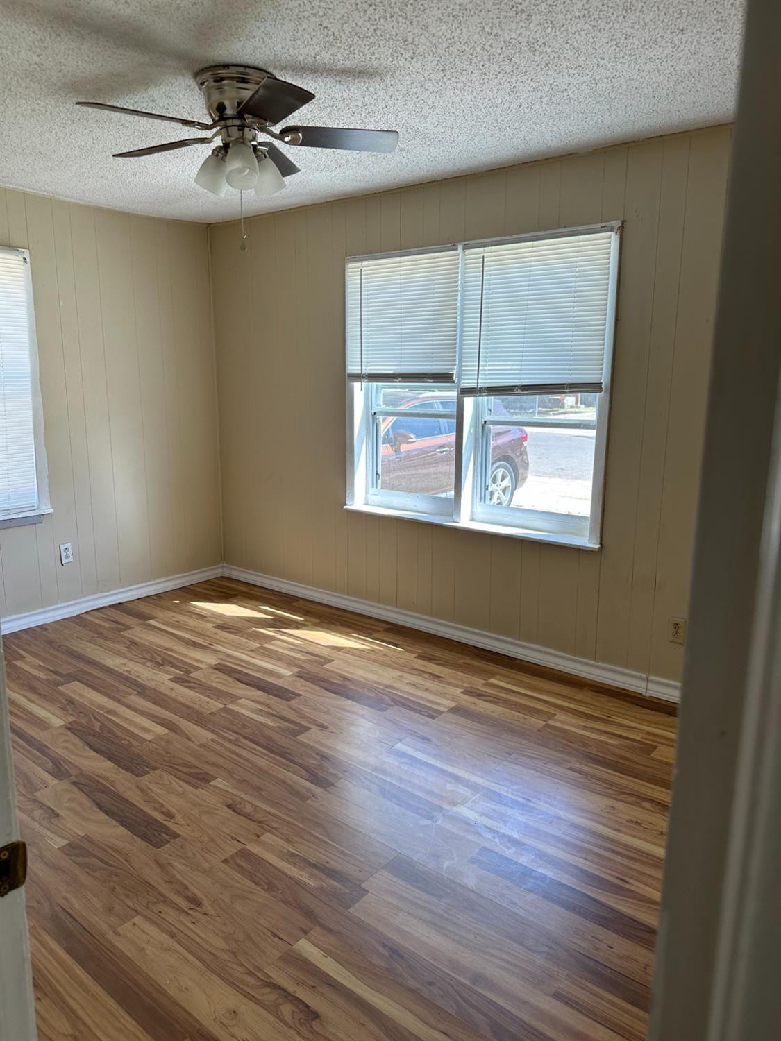 1110 46th Street Lubbock, TX 79412 - Photo 9 of 12 a view of empty room with wooden floor and fan
