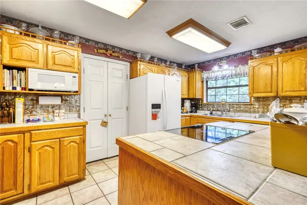 a kitchen with stainless steel appliances granite countertop a stove and a refrigerator