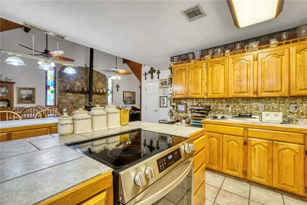 a kitchen with stainless steel appliances granite countertop a sink and cabinets
