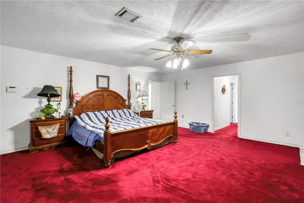 a bedroom with a bed window and couch