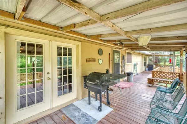 a view of a chairs and table in the deck under an umbrella