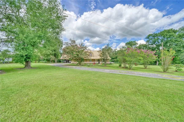 a view of field with trees in the background