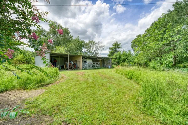 a view of a house with a yard and garage