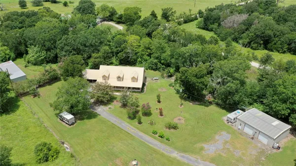 an aerial view of a house with a yard