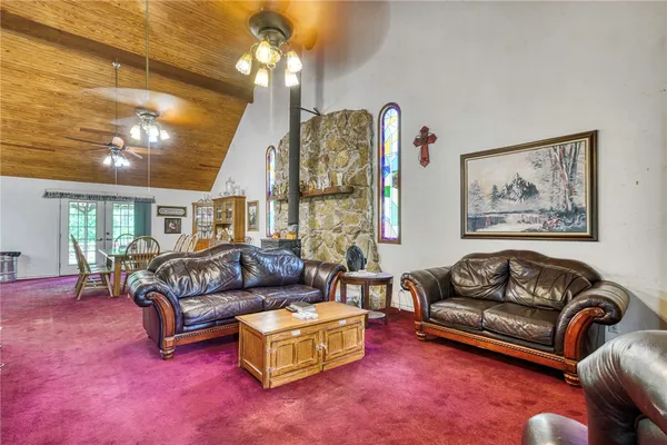 a living room with furniture a couch and chandelier