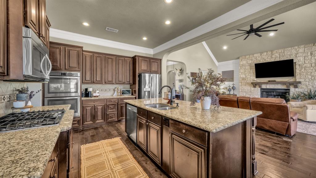 1600 Logans Run Road Perrin, TX 76486 - Photo 40 of 40 a kitchen with kitchen island granite countertop a sink appliances and cabinets