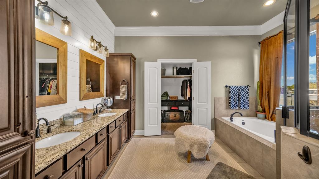 1600 Logans Run Road Perrin, TX 76486 - Photo 15 of 40 a spacious bathroom with a double vanity sink tub and mirror
