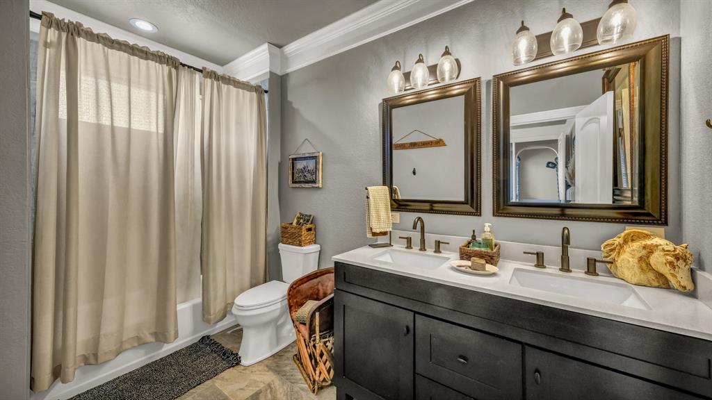 1600 Logans Run Road Perrin, TX 76486 - Photo 18 of 40 a bathroom with a sink a toilet and a mirror